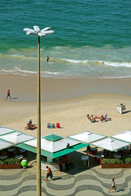 Вид с воздуха на людей, наслаждающихся развлечениями на пляже Копакабана в Рио-де-Жанейро, Бразилия