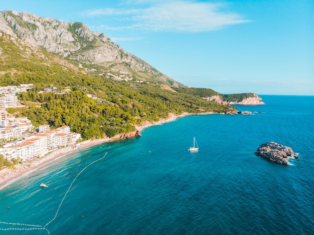 Aerial view of people sunbathing at seaside in evening time