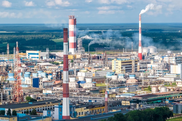 Aerial view on pipes of chemical enterprise plant Air pollution concept Industrial landscape environmental pollution waste of thermal power plant