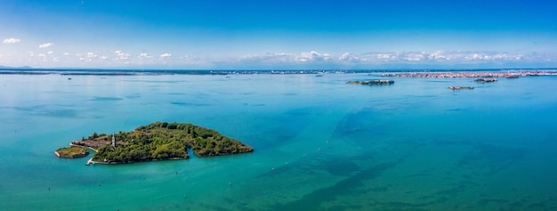 Aerial view of the plagued ghost island of Poveglia in the Venetian lagoon, opposite Malamocco along the Canal Orfano near Venice, Italy.