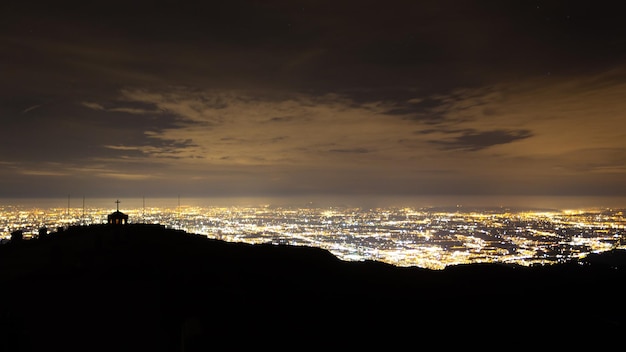 Aerial view of a plain illuminated by electric light. Mount Grappa war memorial, Italian landscape