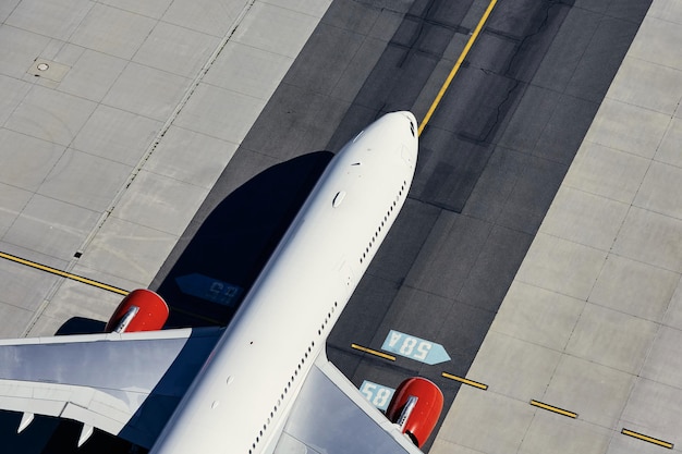 Aerial view of plane at airport airplane taxiing to runway before take off