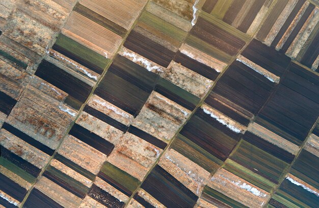 Aerial view of plowed agricultural field prepared for planting crops in spring