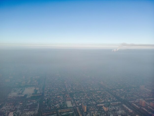 Aerial view of polluted city covered with smog