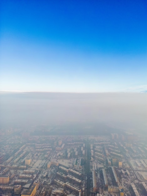 Aerial view of polluted city covered with smog