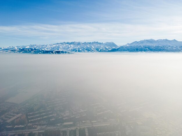 Aerial view of polluted city covered with smog