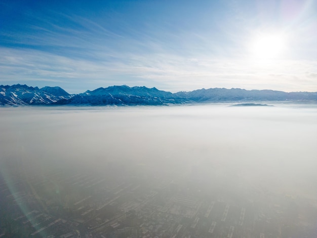 Aerial view of polluted city covered with smog