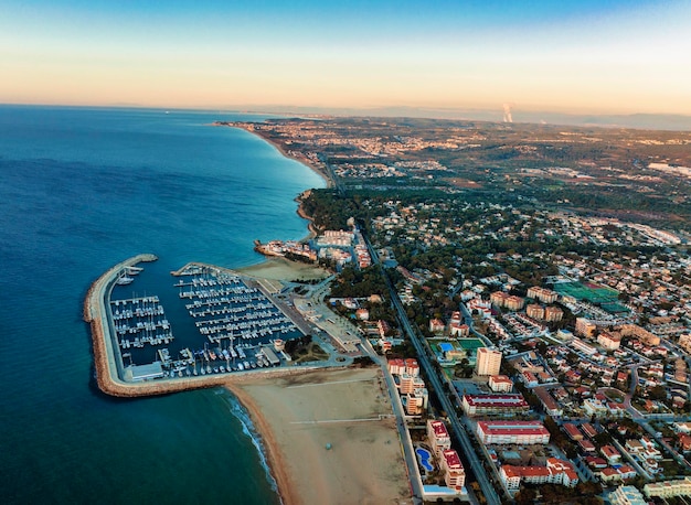 Aerial view of port with moored boats and coastal city