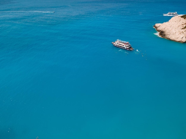 Aerial view of porto katsiki beach with cruise boat people having fun