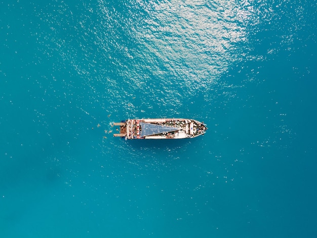 Aerial view of porto katsiki beach with cruise boat people having fun