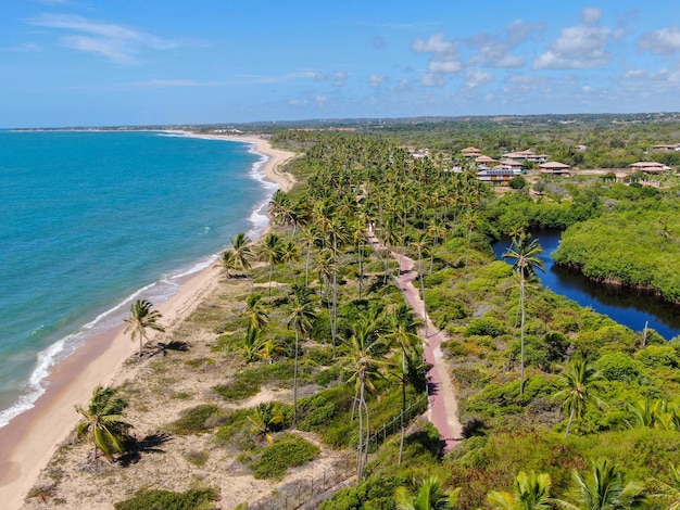 Aerial view of Praia Do Forte coastline town with blue ocean Bahia Brazil Tropical destination