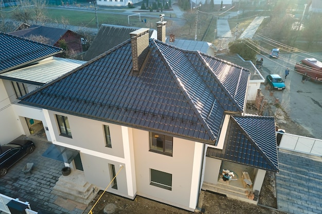 Aerial view of private house with ceramic shingles covered roof top Investment in real estate concept