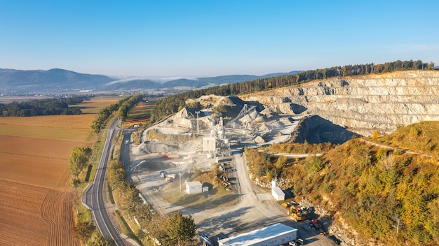 Aerial view of a quarry with a lot of work equipment, mining of stone and sand in large quantities