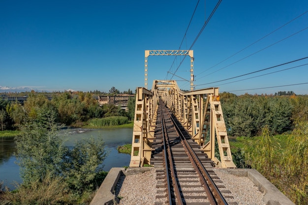 Aerial view of the railroad bridge above a river in Maule region Chile Top view of the railroad from drone