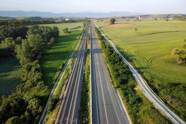 Aerial view, railway and road in rural landscape.