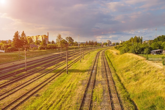 Aerial view on railway tracks against beautiful sky at sunset\
cargo shipping travel background