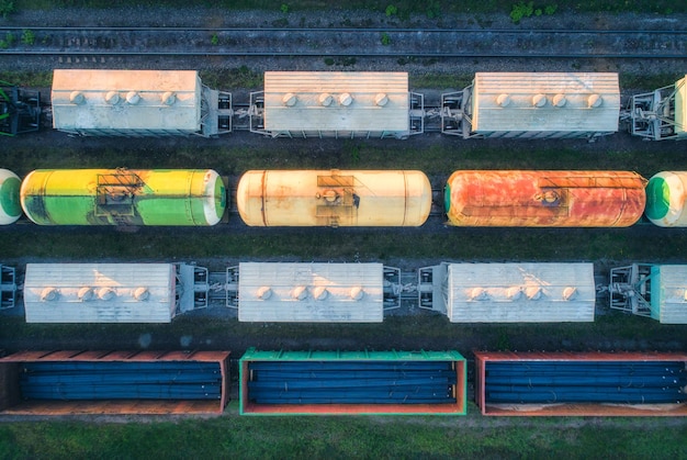 Aerial view of railway wagons Cargo trains Top view of colorful freight train on the railway station Wagons with goods on railroad Heavy industry Industrial conceptual landscape Transportation