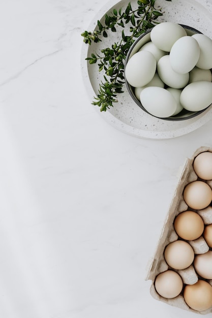 Aerial view of raw eggs on a white marble table