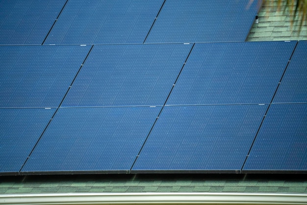 Aerial view of regular american home roof with blue solar photovoltaic panels for producing clean ecological electric energy Renewable electricity with zero emission concept