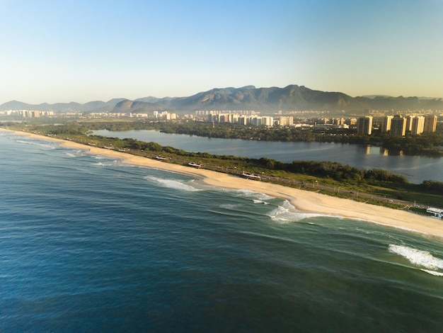 Aerial view of Reserva beach Marapendi lagoon and car traffic on Lucio Costa avenue Barra da Tijuca and Recreio in Rio de Janeiro Brazil Sunrise Sunny day Drone photo Praia da Reserva