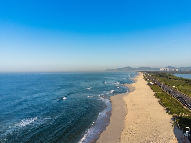 Aerial view of Reserva beach Marapendi lagoon and car traffic on Lucio Costa avenue Barra da Tijuca and Recreio in Rio de Janeiro Brazil Sunrise Sunny day Drone photo Praia da Reserva