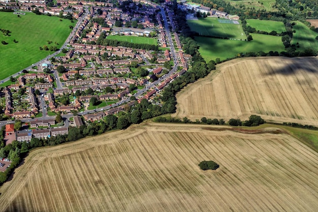 aerial view of residential district by field