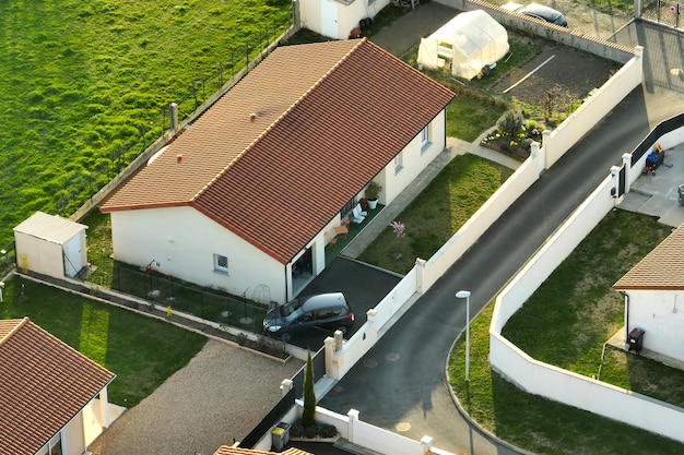 Aerial view of residential houses in green suburban rural area