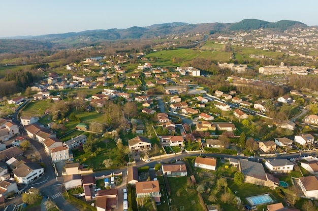 Aerial view of residential houses in green suburban rural area