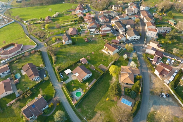 Aerial view of residential houses in green suburban rural area