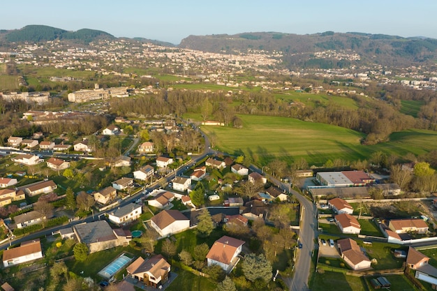 Aerial view of residential houses in green suburban rural area