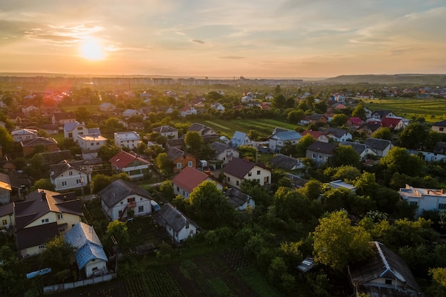 Aerial view of residential houses in suburban rural area at sunset