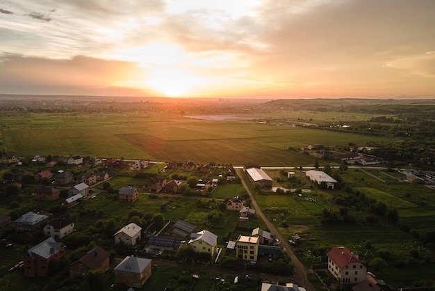 Aerial view of residential houses in suburban rural area at sunset