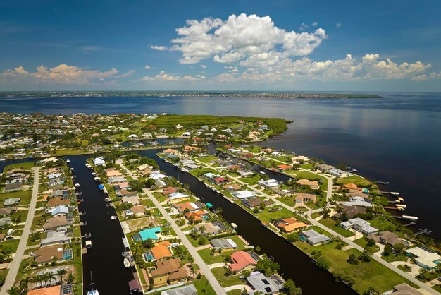 Aerial view of residential suburbs with private homes located on gulf coast near wildlife wetlands with green vegetation on sea shore Living close to nature concept