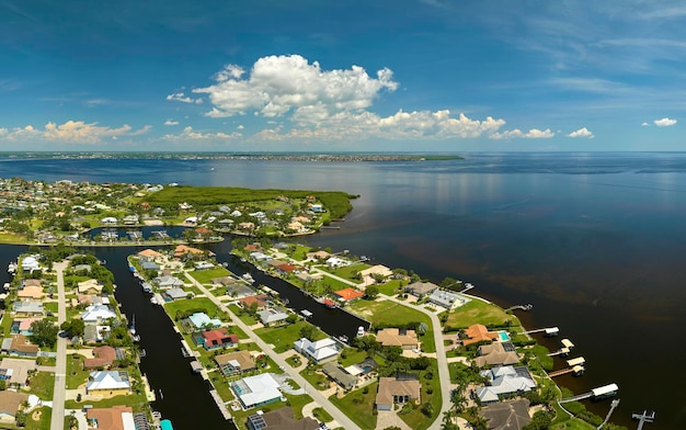 Aerial view of residential suburbs with private homes located on gulf coast near wildlife wetlands with green vegetation on sea shore Living close to nature concept