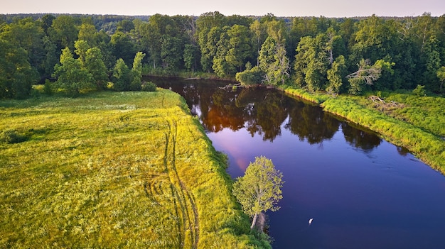 Aerial view river green meadows beautiful sunset light Evening panorama Birch trees riverbank