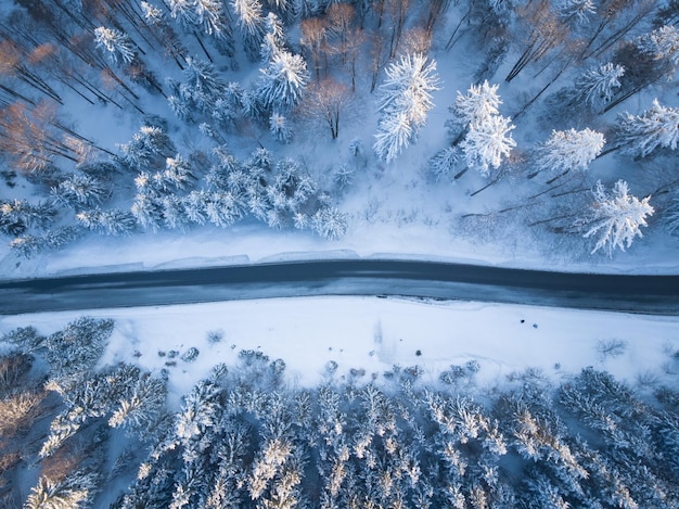 Aerial view of road amidst forest during winter