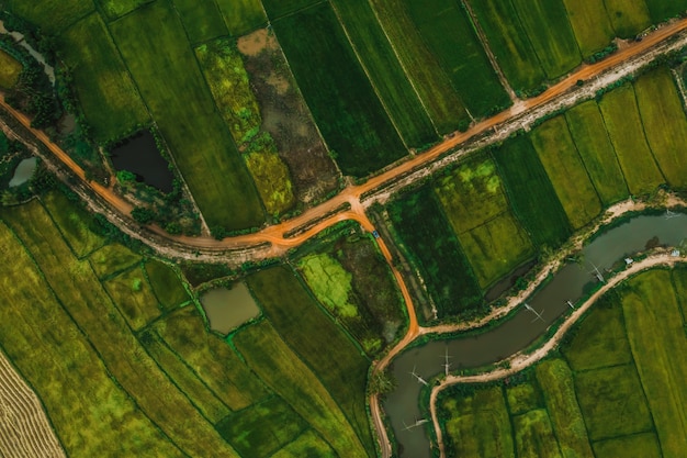 aerial view of road and devious river in a fields