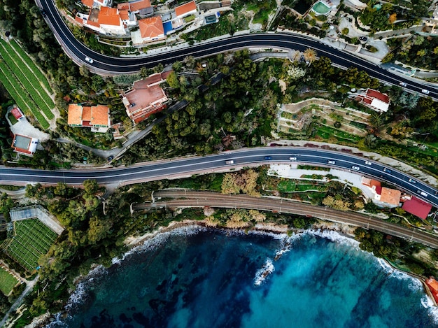 Veduta aerea dell'autostrada e della ferrovia che costeggiano l'oceano o il mare fotografia di droni dall'alto nell'italia rurale