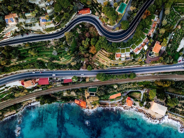 Aerial view of road highway and railway going along ocean or sea Drone photography from above in rural Italy