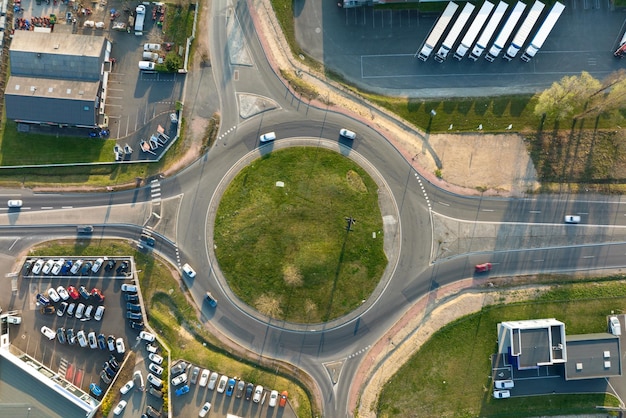 Aerial view of road roundabout intersection with moving heavy traffic Urban circular transportation crossroads