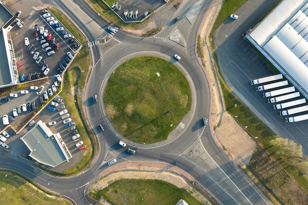 Photo aerial view of road roundabout intersection with moving heavy traffic urban circular transportation crossroads