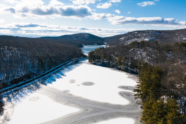 Aerial view of road with snowy forest