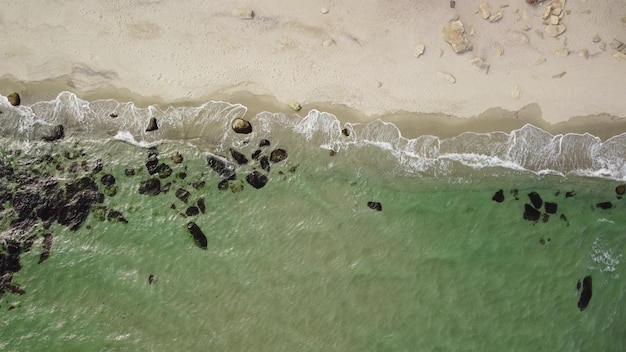 Aerial view of rocky beach and sea waves