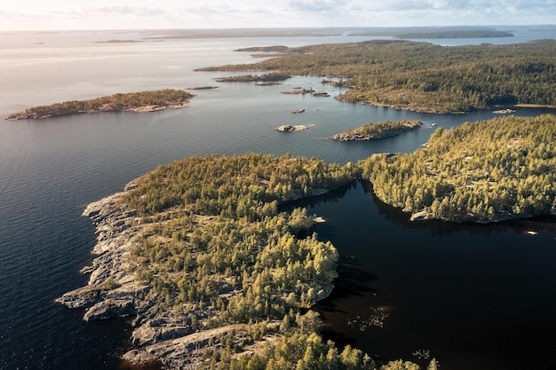 Aerial view of rocky island with jagged coastline overgrown with sparse trees Karelia Russia