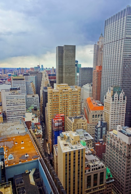 Aerial view on roofs of Lower Manhattan skyscrapers in New York, USA. Jersey City, New Jersey, USA, on the background. East River separates New York and New Jersey.