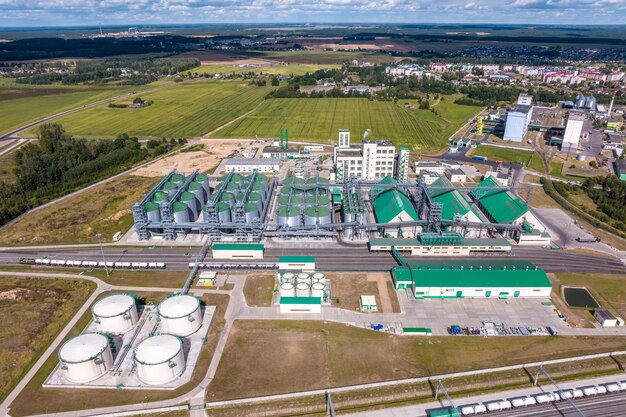 Aerial view on rows of agro silos granary elevator with seeds cleaning line on agroprocessing manufacturing plant for processing drying cleaning and storage of agricultural products