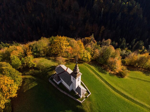 Aerial view of rural church or chapel in Slovenia at autumn