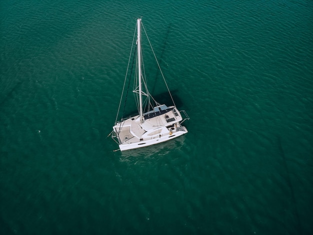 Aerial view of a  sailing yacht in the turquoise water of the Andaman sea. Phuket. Thailand