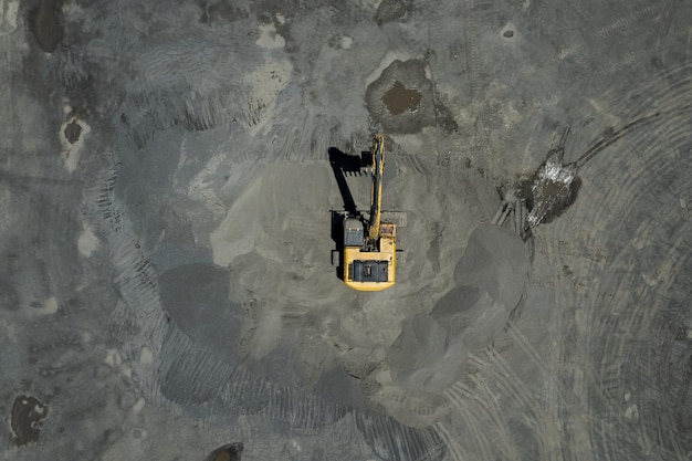 Aerial view of sand loaders are shoveling rocks into dump trucks