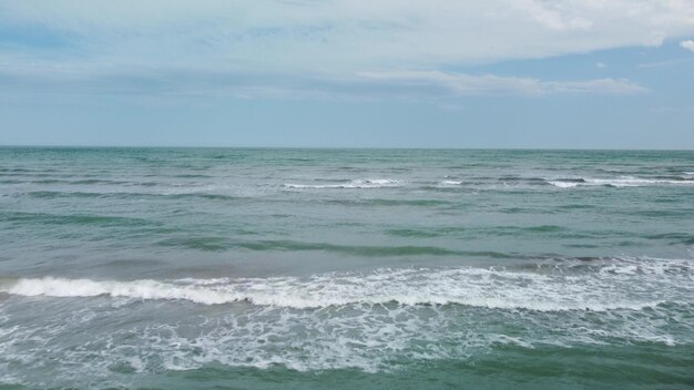 Aerial view of sandy beach and sea waves